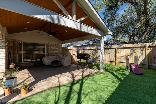 view of patio with ceiling fan, fence, and grilling area