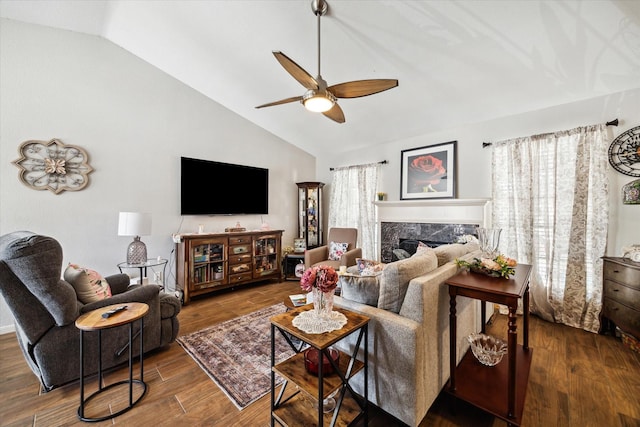 living room featuring ceiling fan, high vaulted ceiling, a fireplace, and wood finished floors