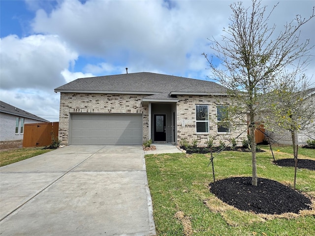 2520 Table Rock Dr, Texas City, TX 77568 - view of front of property featuring brick siding, concrete driveway, a garage, and a front lawn