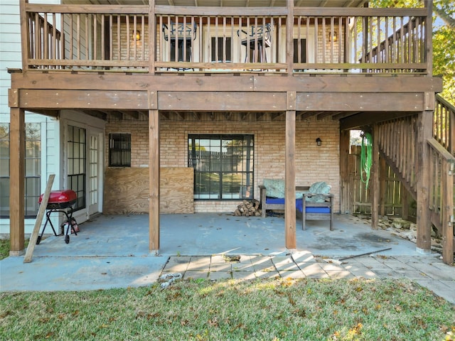 back of property featuring brick siding and a patio