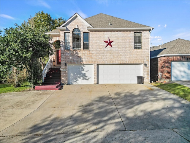 view of front facade with an attached garage, a shingled roof, concrete driveway, and brick siding