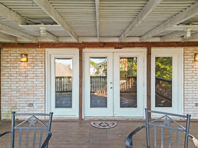 doorway to property featuring french doors and brick siding