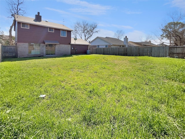 view of yard with a fenced backyard