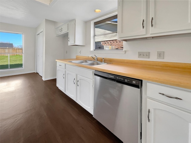 kitchen featuring a sink, white cabinetry, light countertops, stainless steel dishwasher, and dark wood finished floors