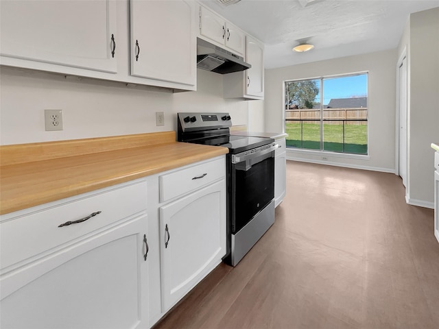 kitchen with under cabinet range hood, wood finished floors, white cabinetry, electric stove, and light countertops