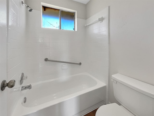 bathroom featuring shower / tub combination and toilet