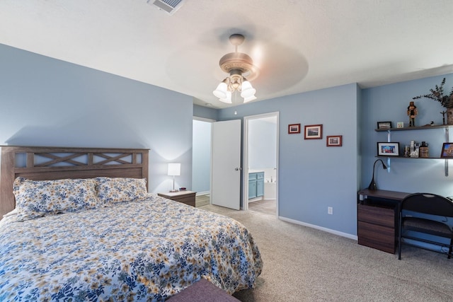 bedroom featuring ceiling fan, light colored carpet, visible vents, baseboards, and ensuite bath