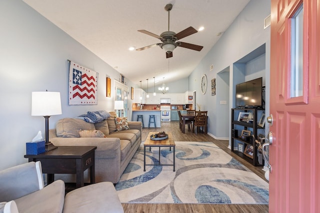 living room with visible vents, lofted ceiling, wood finished floors, ceiling fan with notable chandelier, and recessed lighting