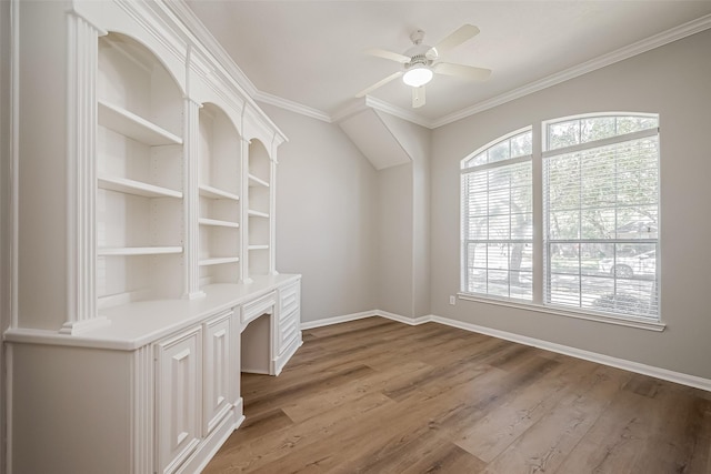 unfurnished office featuring ornamental molding, light wood-style floors, baseboards, and ceiling fan