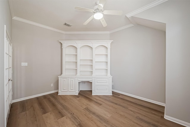 unfurnished office featuring baseboards, visible vents, ceiling fan, ornamental molding, and wood finished floors