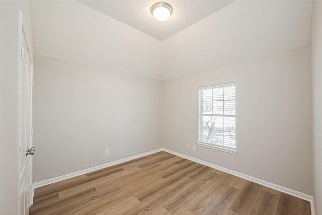 empty room featuring baseboards and wood finished floors