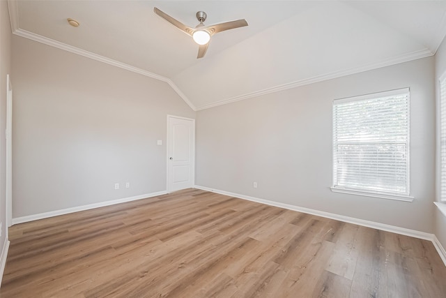 spare room featuring lofted ceiling, light wood-type flooring, baseboards, and ceiling fan