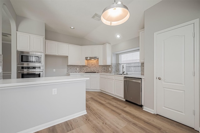 kitchen with appliances with stainless steel finishes, visible vents, under cabinet range hood, and white cabinetry