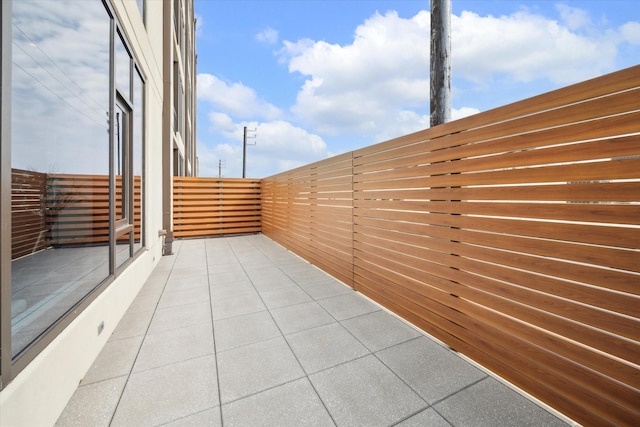 view of patio featuring a balcony