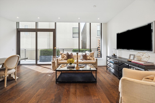 living room with a wall of windows, wood finished floors, and recessed lighting