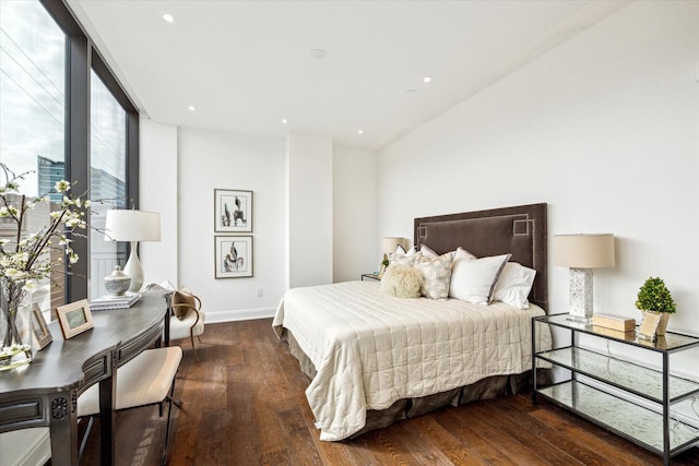 bedroom with recessed lighting, dark wood finished floors, expansive windows, and baseboards