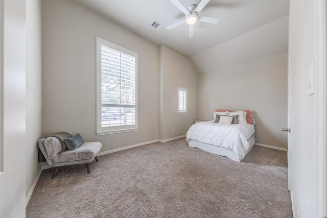 carpeted bedroom featuring lofted ceiling, a ceiling fan, visible vents, and baseboards