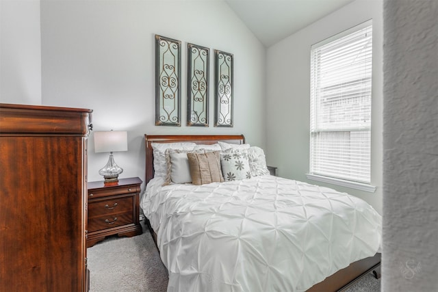 carpeted bedroom featuring lofted ceiling