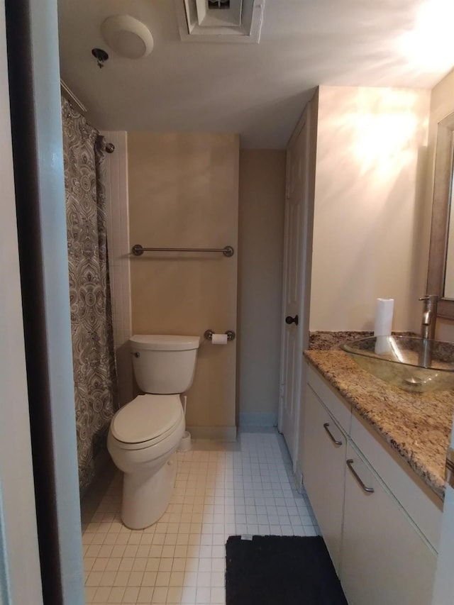 bathroom with tile patterned flooring, toilet, visible vents, vanity, and baseboards