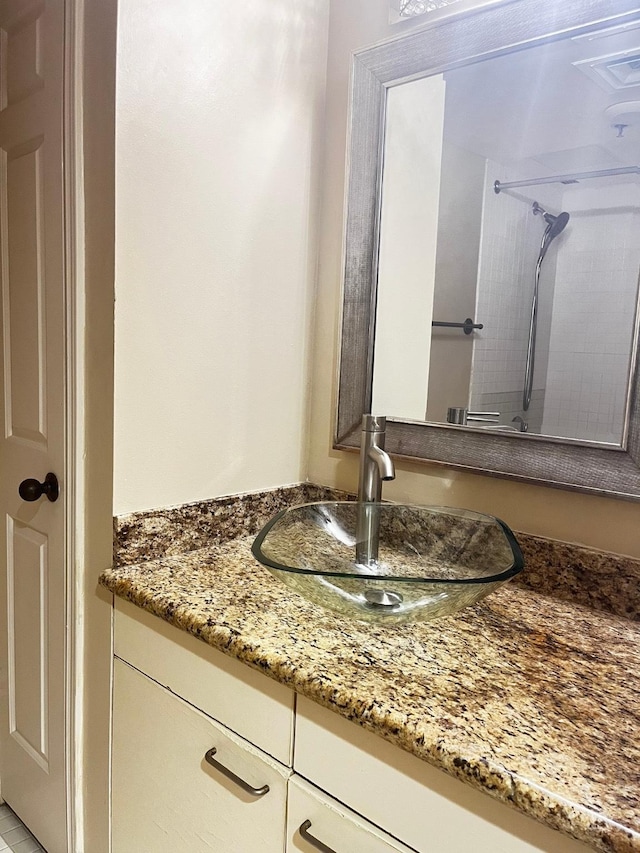details featuring walk in shower and vanity