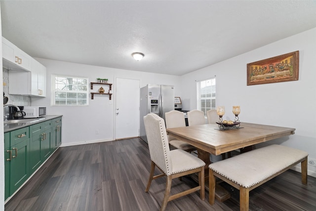 dining area featuring dark wood-style floors, plenty of natural light, and baseboards