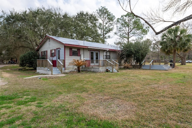 view of front of house featuring a front yard and a wooden deck