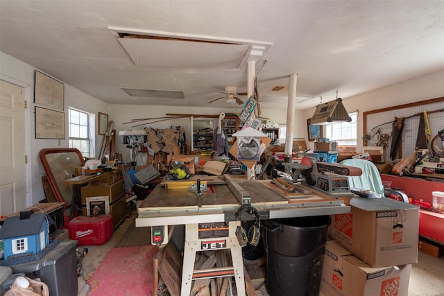 garage with ceiling fan and a workshop area