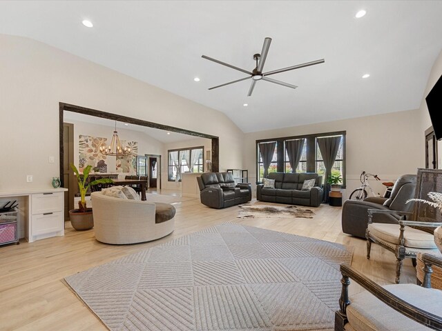 living area with ceiling fan with notable chandelier, vaulted ceiling, light wood-style flooring, and recessed lighting