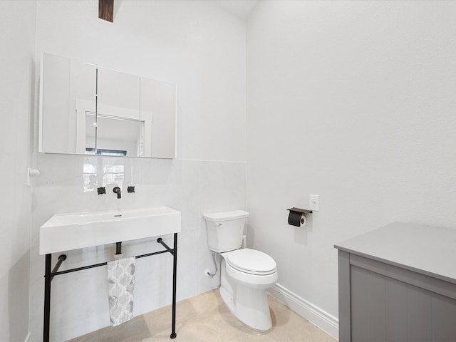 bathroom with toilet and a sink