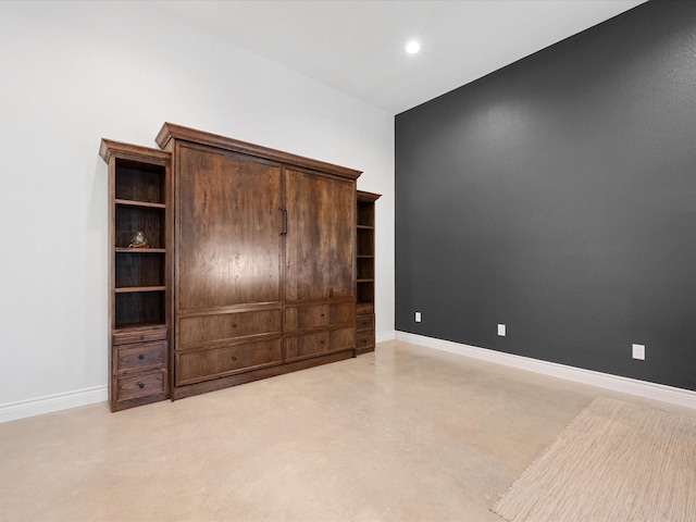 unfurnished bedroom with recessed lighting, baseboards, and concrete floors