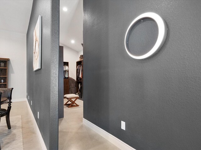 corridor with recessed lighting, baseboards, and a textured wall