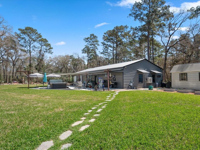 view of yard featuring a patio area and a hot tub