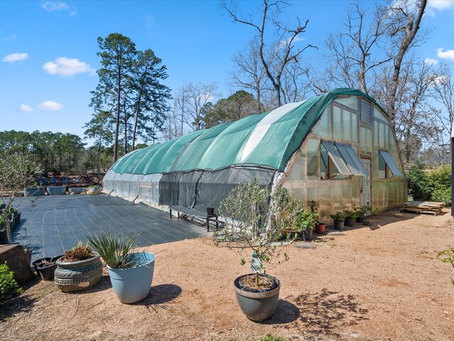 view of yard with a greenhouse and an outdoor structure