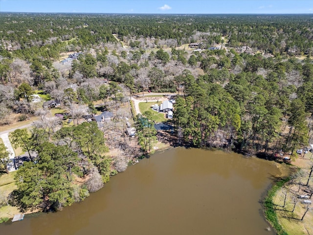 aerial view with a wooded view and a water view