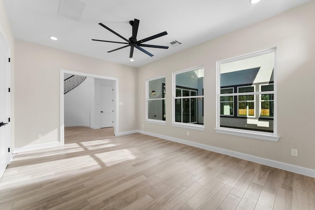 empty room with recessed lighting, visible vents, baseboards, and wood finished floors