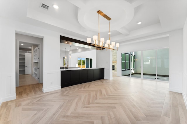 spare room with recessed lighting, visible vents, a decorative wall, an inviting chandelier, and coffered ceiling