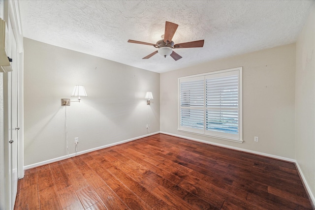 unfurnished room featuring ceiling fan, hardwood / wood-style floors, a textured ceiling, and baseboards