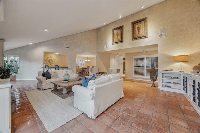 tiled living room with high vaulted ceiling, visible vents, and recessed lighting