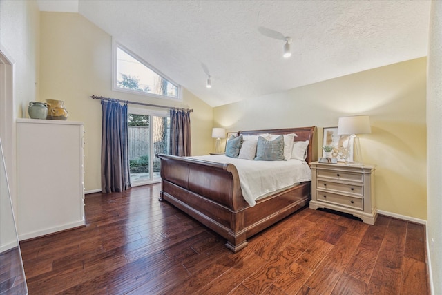 bedroom featuring access to outside, wood-type flooring, vaulted ceiling, and a textured ceiling