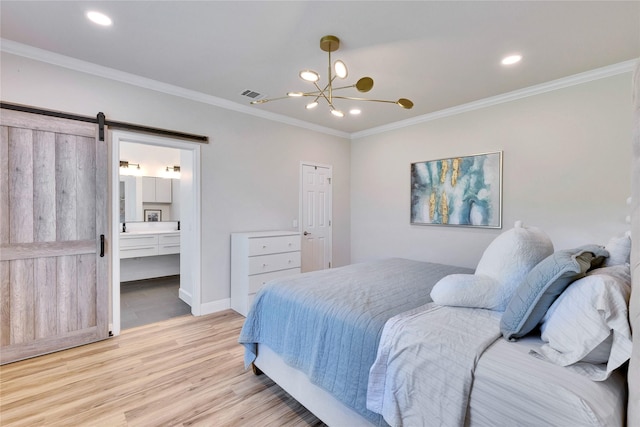 bedroom featuring a barn door, visible vents, baseboards, light wood-style floors, and ornamental molding