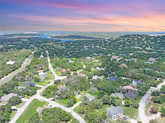 aerial view at dusk with a water view