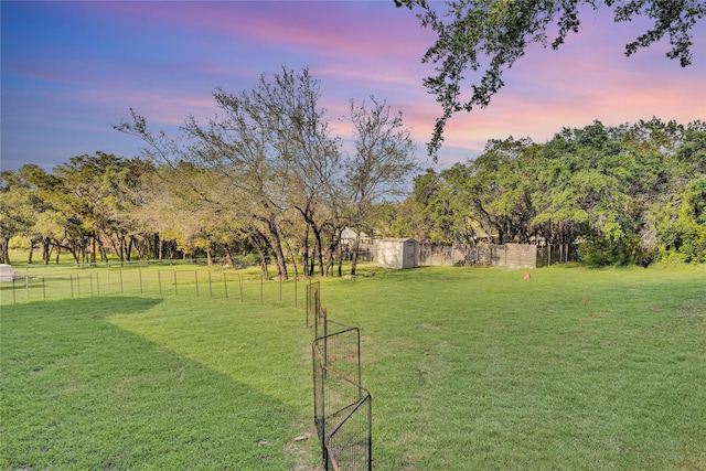 view of yard featuring fence and an outdoor structure