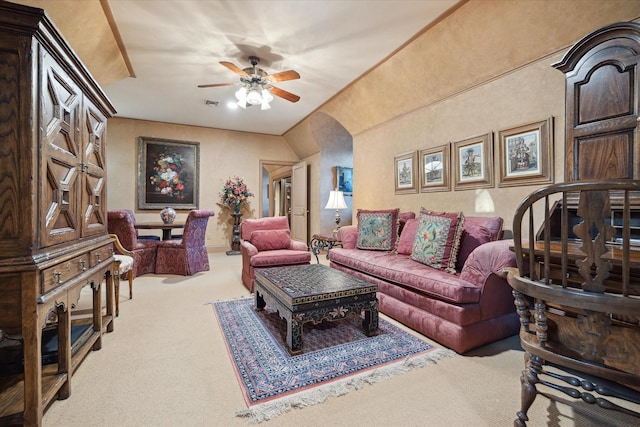 living room with arched walkways, visible vents, carpet flooring, and a ceiling fan