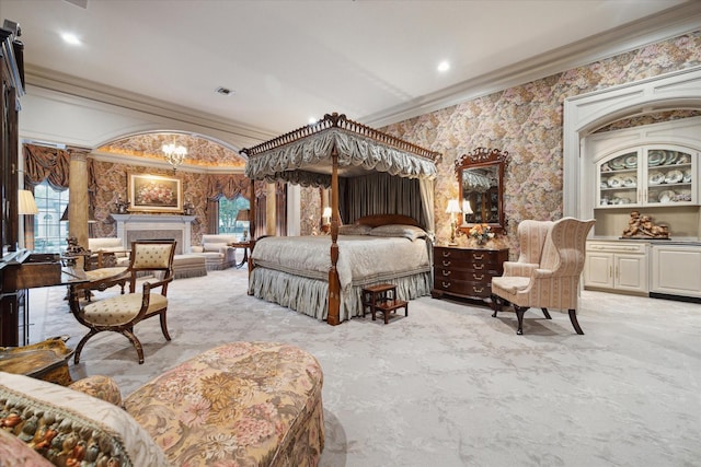 bedroom featuring a chandelier, recessed lighting, a premium fireplace, visible vents, and ornamental molding