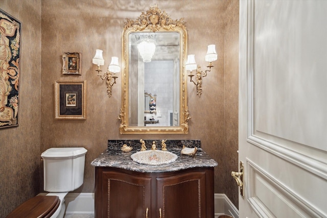 bathroom featuring toilet and vanity