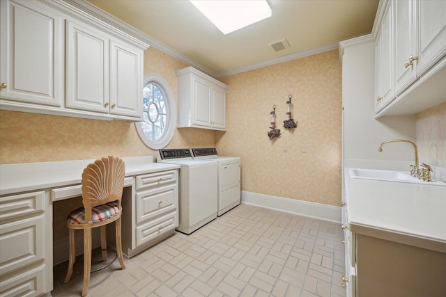 clothes washing area featuring wallpapered walls, baseboards, cabinet space, and washing machine and clothes dryer