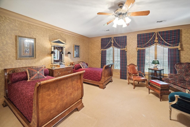 carpeted bedroom featuring ornamental molding, a ceiling fan, visible vents, and wallpapered walls