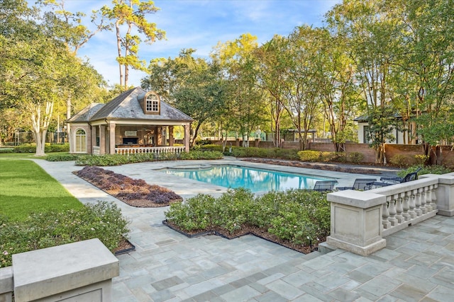 outdoor pool with an exterior structure, a patio area, an outdoor structure, and fence