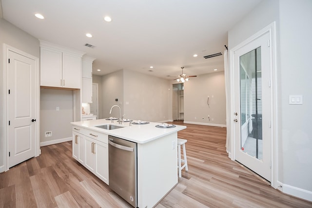 kitchen with recessed lighting, white cabinets, a sink, and stainless steel dishwasher