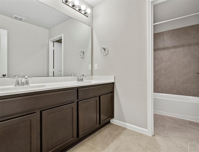 full bathroom with double vanity, a sink, visible vents, and tile patterned floors